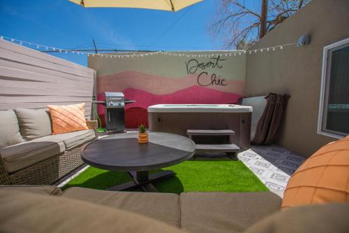 a small patio with a table and a couch at East Downtown Desert Chic Casita-Hot Tub-Pet Friendly-No Pet Fees! in Albuquerque