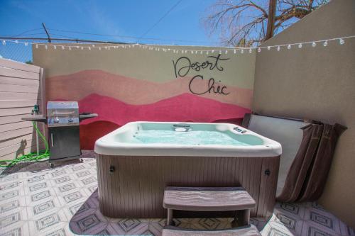 a jacuzzi tub with a bench in front of a wall at East Downtown Desert Chic Casita-Hot Tub-Pet Friendly-No Pet Fees! in Albuquerque