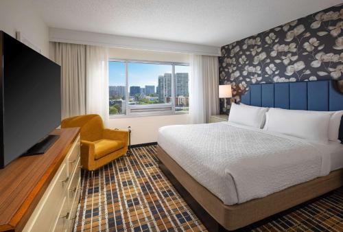 アトランタにあるEmbassy Suites by Hilton Atlanta Buckheadのベッドとテレビが備わるホテルルームです。