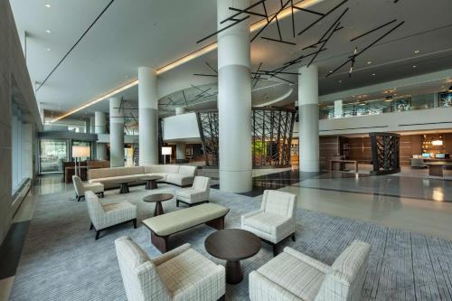 a lobby with couches and tables in a building at Hilton Cleveland Downtown in Cleveland