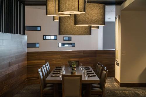 a dining room with a table and chairs and lights at Hilton Cleveland Downtown in Cleveland