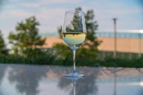 a glass of wine sitting on top of a table at Hilton Cleveland Downtown in Cleveland