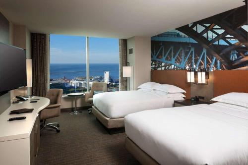 a hotel room with two beds and a large window at Hilton Cleveland Downtown in Cleveland