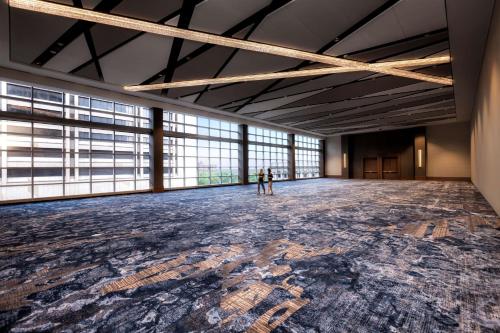 two people standing in a large room with a large floor at Hilton Cleveland Downtown in Cleveland