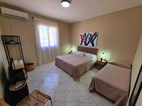 a bedroom with two beds and a window at Casa Calilla - 30m dal mare in Lampedusa