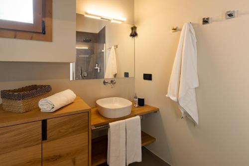 a bathroom with a sink and a mirror at Maison Luboz - Courmayeur in Courmayeur