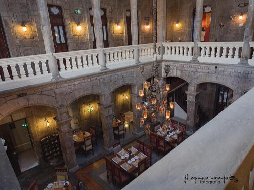 an overhead view of a building with tables and chairs at Roka Plaza Hotel Boutique in Ambato