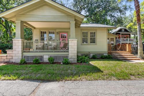 a yellow house with a porch and a balcony at Flagler Cottage - 1 Block to Historic District in St. Augustine