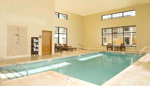 a large swimming pool in a house with a swimming pool at Homewood Suites by Hilton Bozeman in Bozeman