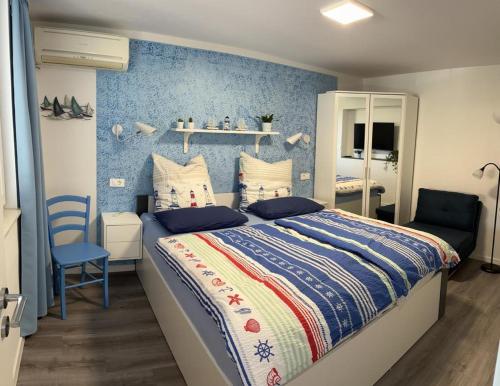 a bedroom with a bed and a blue wall at Apartment Emma in Piran
