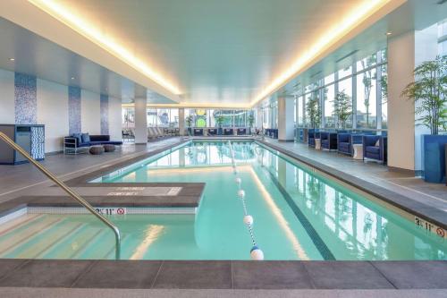 a large swimming pool in a large building at Embassy Suites By Hilton Seattle Downtown Pioneer Square in Seattle