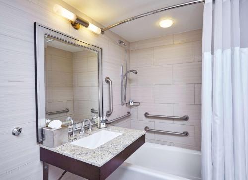a bathroom with a sink and a shower at DoubleTree by Hilton Washington DC – Crystal City in Arlington
