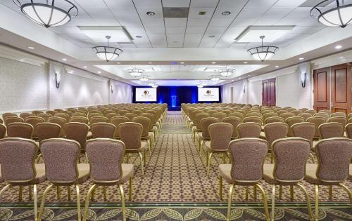an empty room with rows of chairs in a room at DoubleTree by Hilton Washington DC – Crystal City in Arlington