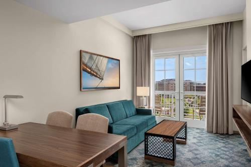 a living room with a couch and a table at Embassy Suites by Hilton Charleston Harbor Mt. Pleasant in Charleston