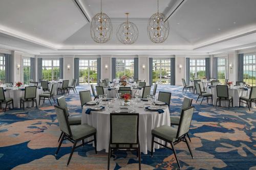 a banquet room with tables and chairs and chandeliers at Embassy Suites by Hilton Charleston Harbor Mt. Pleasant in Charleston