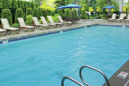 a large swimming pool with chairs and umbrellas at DoubleTree by Hilton Spokane City Center in Spokane