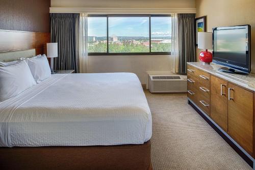 a hotel room with a bed and a flat screen tv at DoubleTree by Hilton Spokane City Center in Spokane