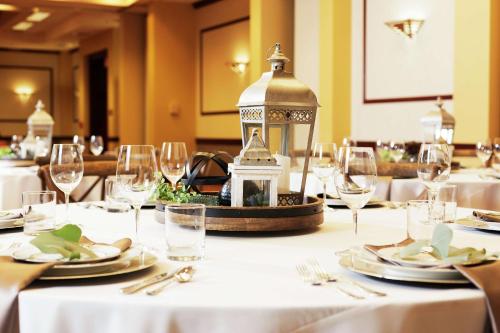 a table with white table cloth and glasses and a lantern at DoubleTree by Hilton Spokane City Center in Spokane