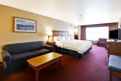 a hotel room with a bed and a couch at Hampton Inn Bozeman in Bozeman