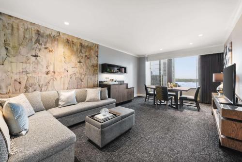 a living room with a couch and a table at Hilton Motif Seattle in Seattle