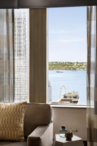 a living room with a couch and a large window at Hilton Motif Seattle in Seattle