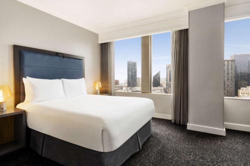 a hotel room with a bed and a large window at Hilton Motif Seattle in Seattle