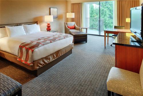 a hotel room with a bed and a desk and a television at DoubleTree by Hilton Seattle Airport in SeaTac