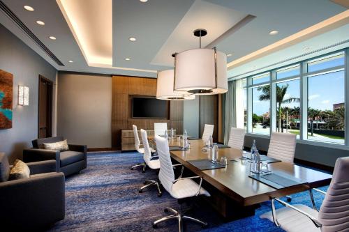 a conference room with a long table and chairs at Hilton West Palm Beach in West Palm Beach