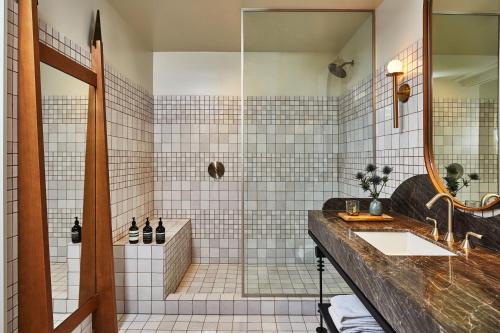 a bathroom with a sink and a shower at Downtown Los Angeles Proper Hotel, a Member of Design Hotels in Los Angeles
