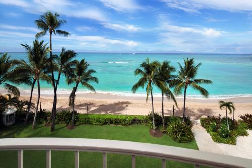 a view of the beach from the balcony of a resort at Moana Surfrider, A Westin Resort & Spa, Waikiki Beach in Honolulu