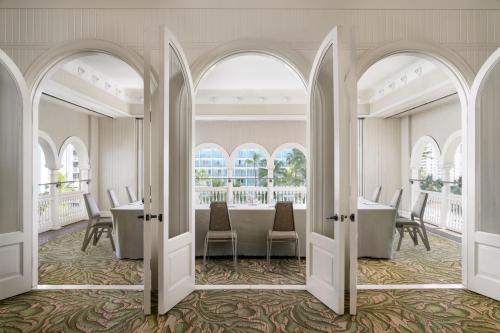 a dining room with a table and chairs at Moana Surfrider, A Westin Resort & Spa, Waikiki Beach in Honolulu