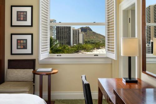 a room with a bed and a desk and a window at Moana Surfrider, A Westin Resort & Spa, Waikiki Beach in Honolulu