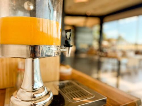 a close up of a drink dispenser on a counter at Backland in Williams