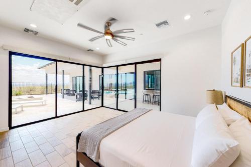 a bedroom with a bed and a ceiling fan at The Sunrise Perch in Tortolita