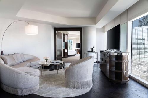 a living room with a couch and chairs and a table at Waldorf Astoria Las Vegas in Las Vegas
