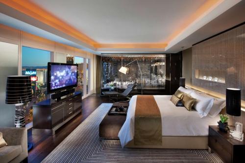 a bedroom with a large bed and a television at Waldorf Astoria Las Vegas in Las Vegas