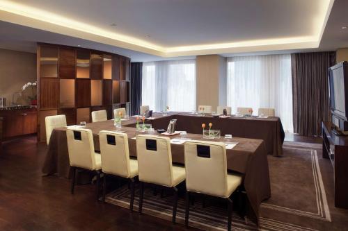 a conference room with a long table and white chairs at Waldorf Astoria Las Vegas in Las Vegas