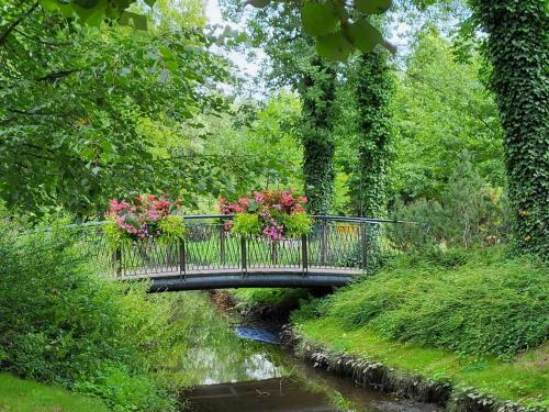 a bridge with flowers on it over a river at Aquarius Kilińskiego 3 in Grodzisk Mazowiecki