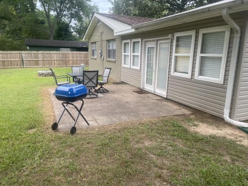 a patio with a table and chairs next to a house at Charming Conway Getaway in Conway