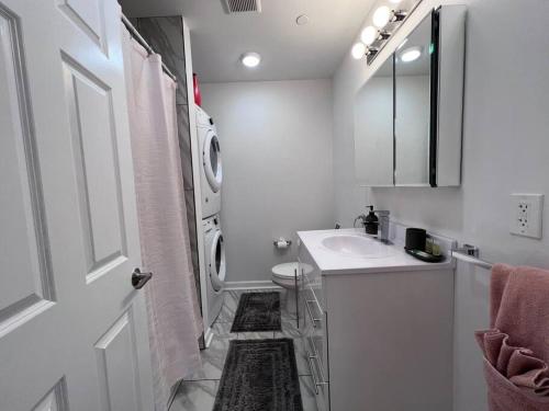 a white bathroom with a sink and a washing machine at Beautiful 1BD With Balcony Hosted By StayRafa - 2F in Philadelphia