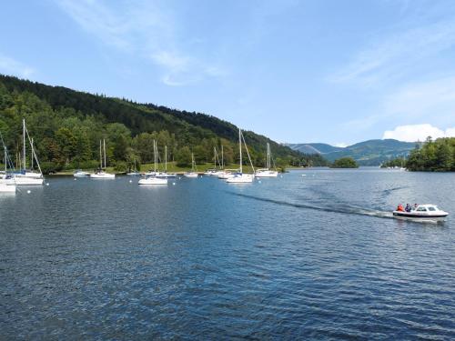 a boat on a lake with boats in the water at Frost in Ambleside