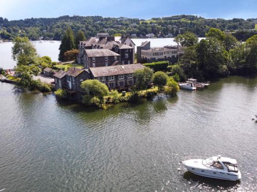 an aerial view of a house and a boat in the water at Frost in Ambleside