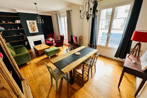 a living room with a wooden table and a dining room at Nice apartment with wifi near town center and Wine Museum in Bordeaux