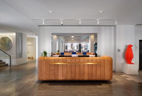 a lobby with a couch in the middle of a room at 21c Museum Hotel St Louis in Saint Louis