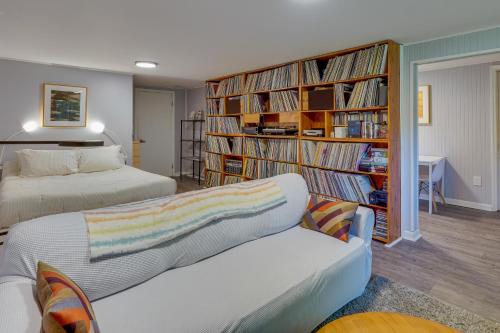 a bedroom with two beds and a book shelf filled with books at Pet-Friendly Staatsburg Studio - Near State Park 