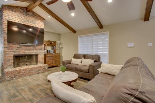 a living room with a couch and a fireplace at Spacious Baton Rouge Home Rental 12 Mi to LSU! in Baton Rouge