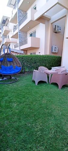 a group of chairs on the grass in a building at مارينا دلتا ولاجونز in Al Ḩammād