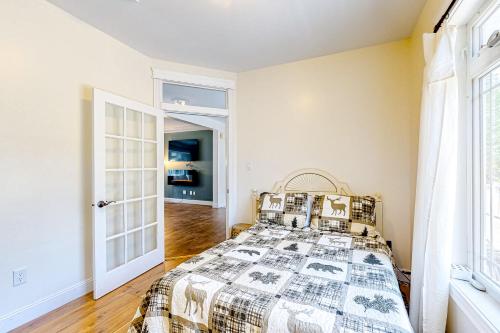 a bedroom with a bed and a window at Maine Country Getaway in Holden