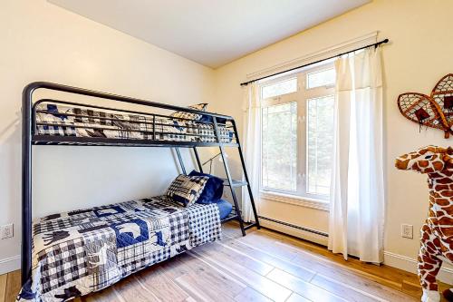 a bedroom with a bunk bed and a window at Maine Country Getaway in Holden