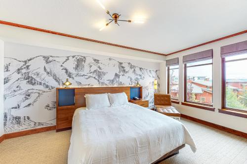a bedroom with a large bed and a mountain mural at Canyons Sunrise in Park City